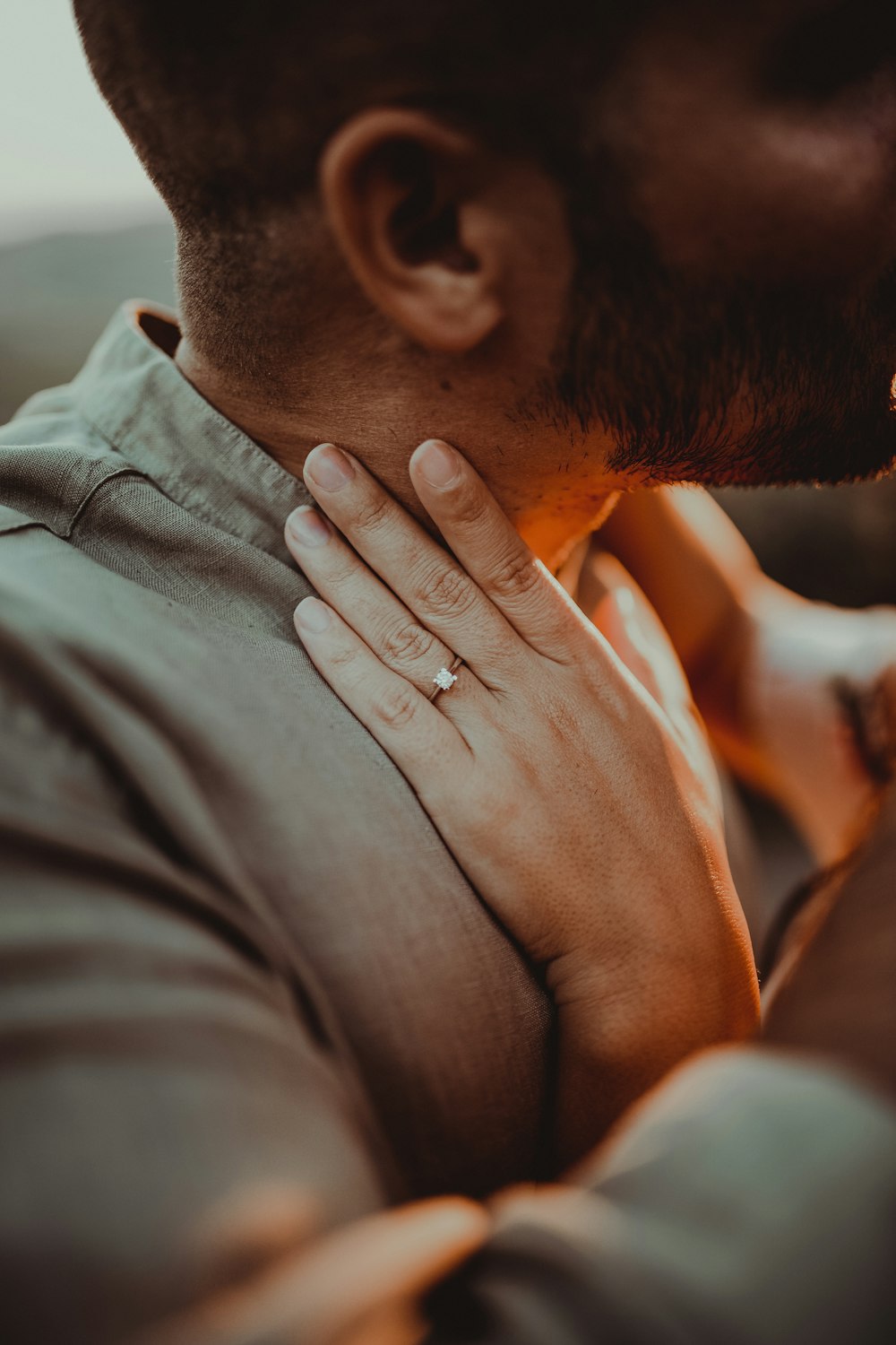 a close up of a person with a ring on their neck