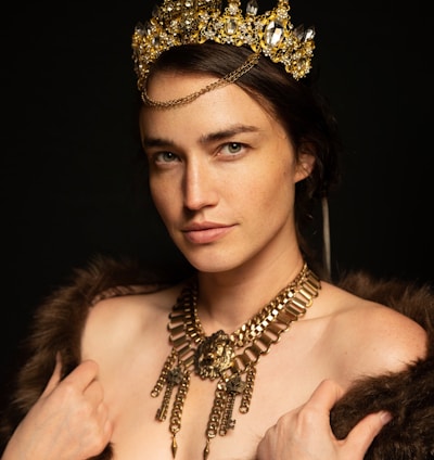 a woman wearing a tiara and a fur coat