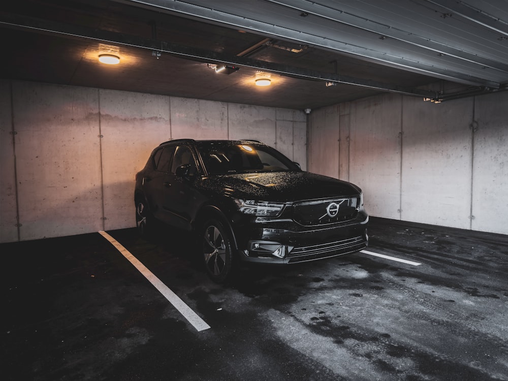 a black car parked in a parking garage