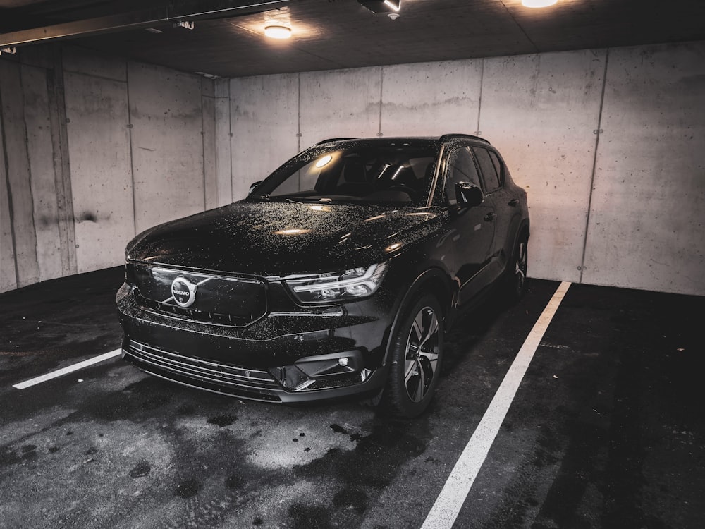 a black car parked in a parking garage