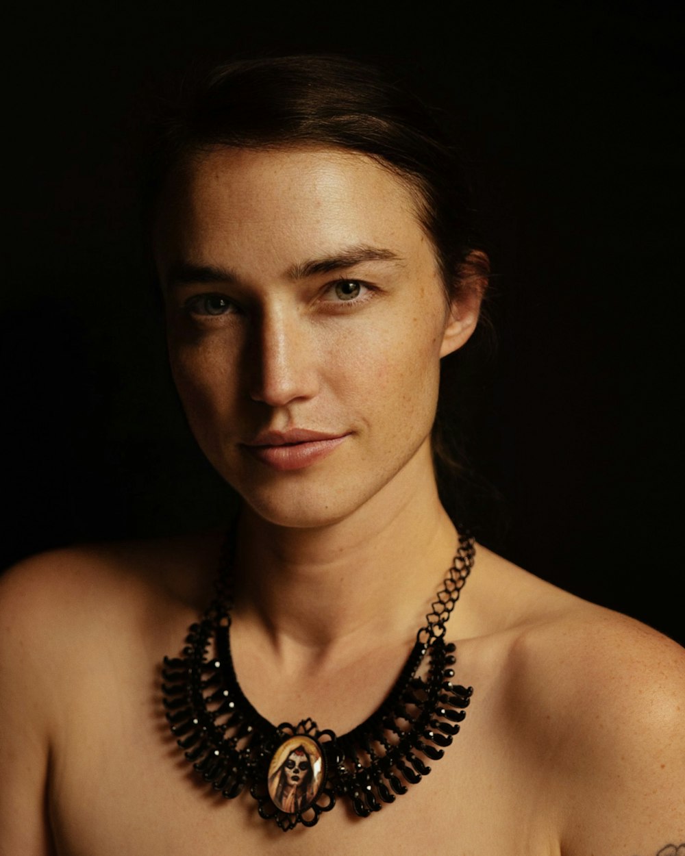 a woman with a necklace on her neck