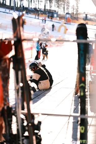 A friendly concierge handing ski equipment to happy guests at a ski resort.
