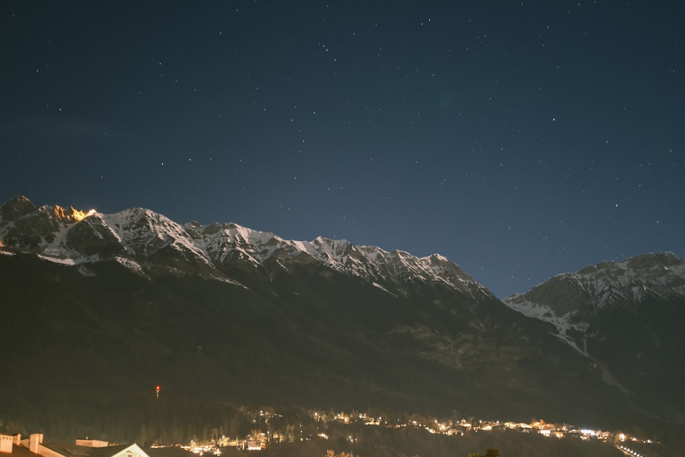 a night time view of a mountain range