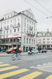 Close-up of a busy street corner with clear detail of pedestrians and vehicles