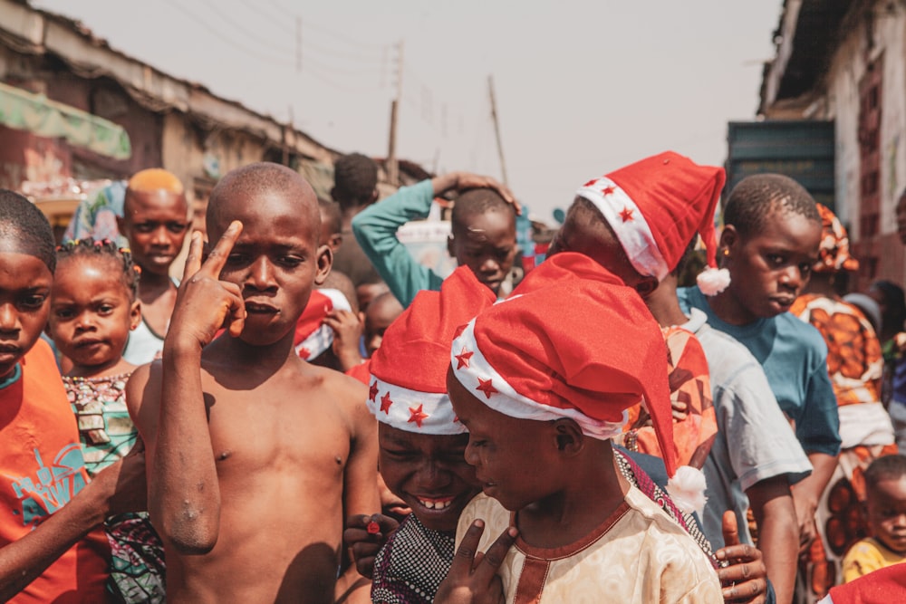 a group of children wearing red and white hats