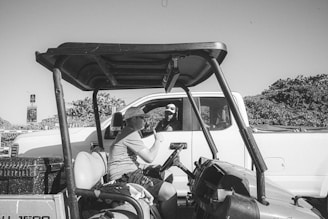 Photo of a truck driver handing over paperwork to a friendly RTS factoring agent at a bustling truck stop.