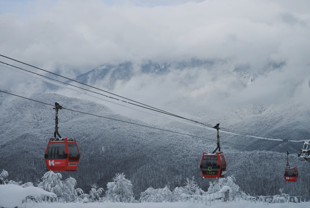 a red ski lift going up a snowy mountain