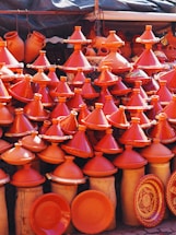 a lot of orange vases that are on display