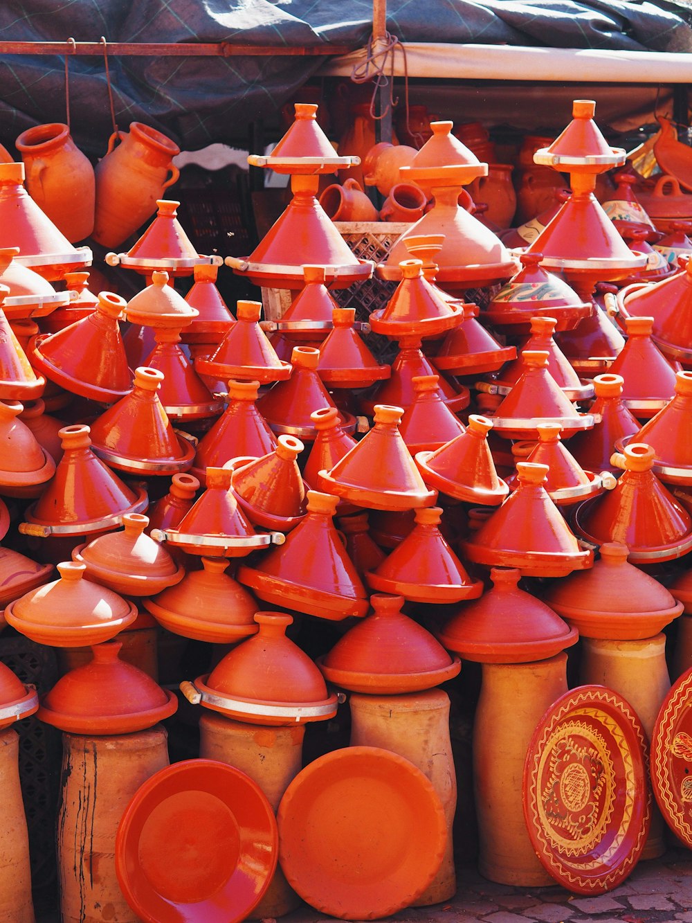 a lot of orange vases that are on display