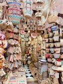 Brightly colored woven baskets stacked neatly in a sunlit market stall.