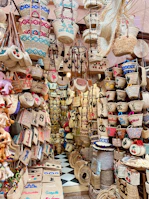 Artisan weaving a jute basket by hand at a lively Biarritz market stall