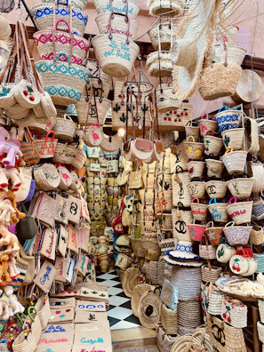 Artisan weaving a jute basket by hand at a lively Biarritz market stall
