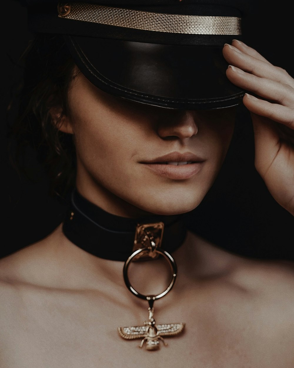 a woman wearing a hat and a choker