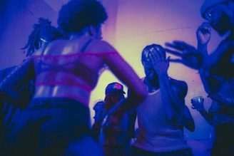 Close-up of partygoers wearing fun costumes and dancing energetically.