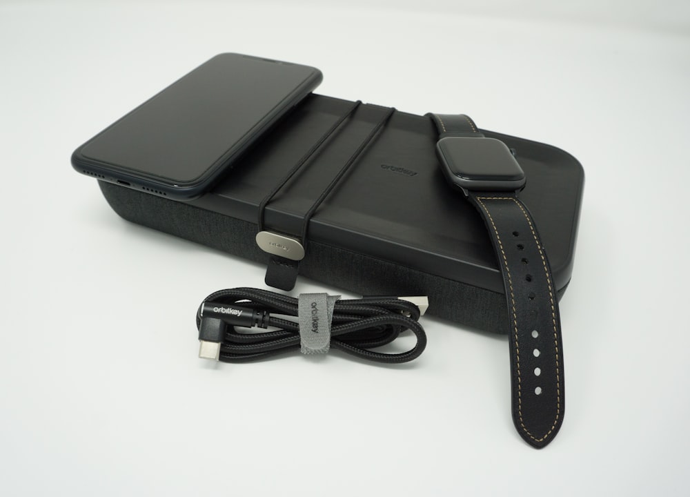 a black case with a black strap and a black apple watch