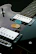 a close up of a guitar picker on a black guitar