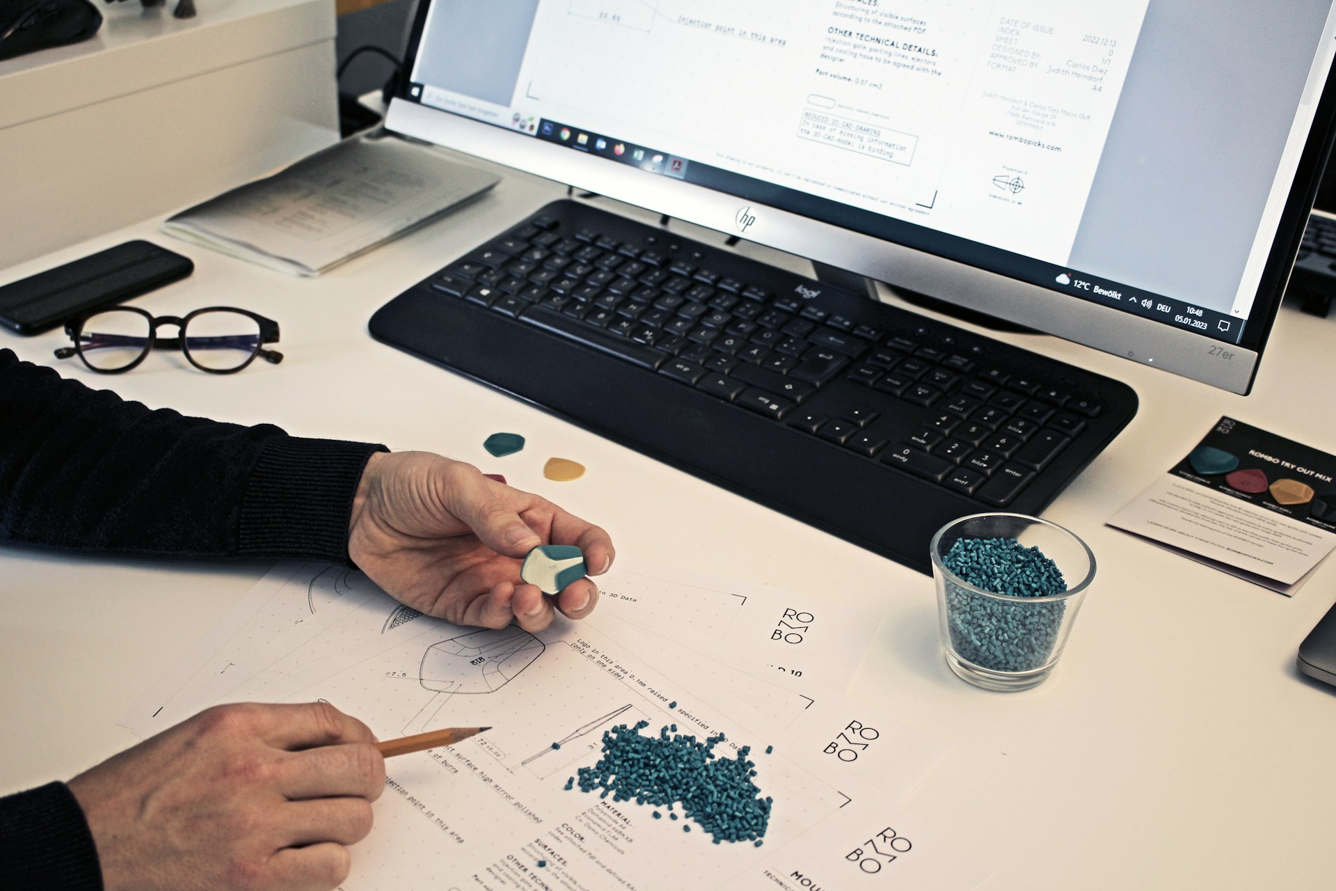 a person sitting at a desk with a pen and paper