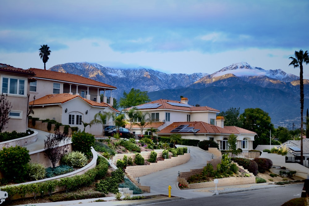 a street with houses and mountains in the background