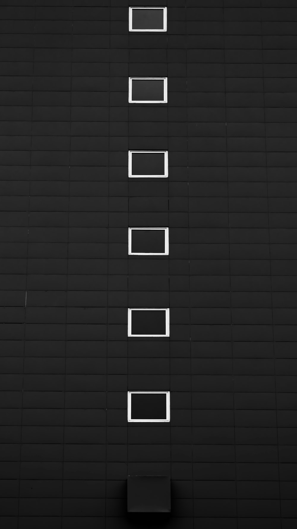 a black and white photo of a wall with squares