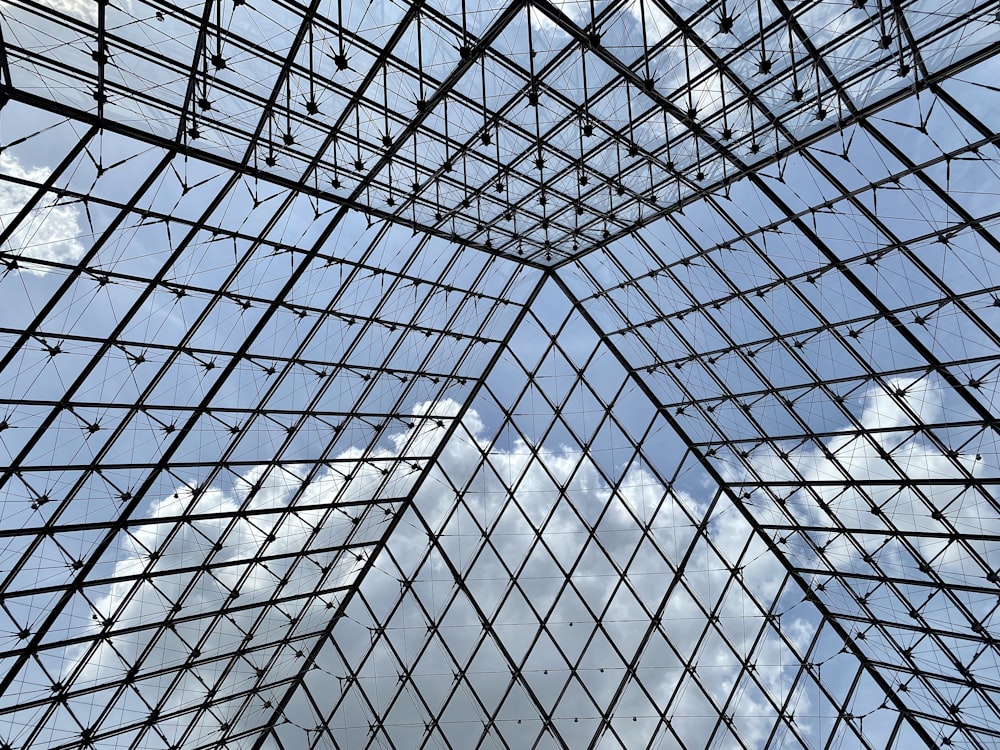 a very tall glass building with a sky in the background