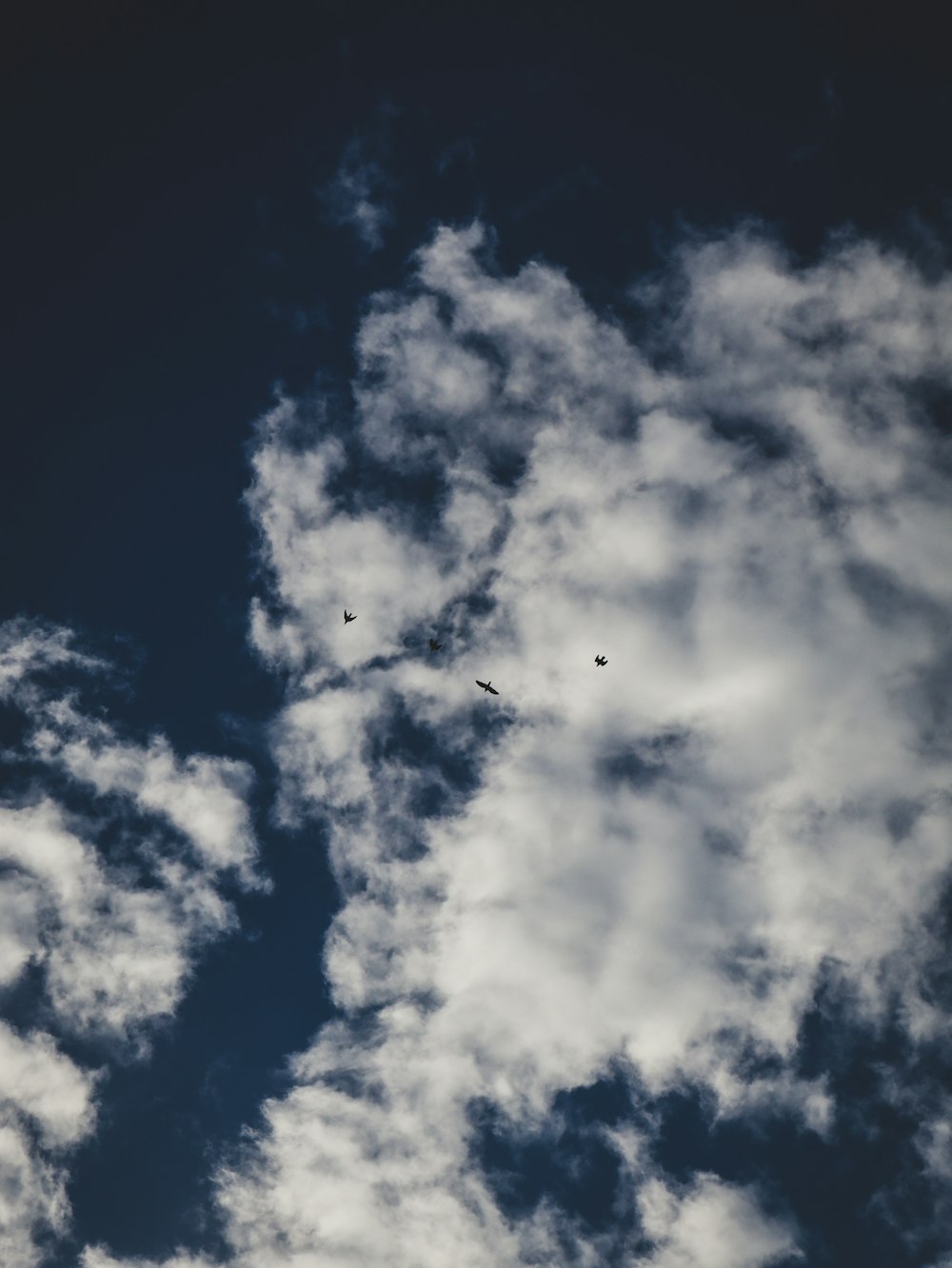a couple of planes flying through a cloudy sky