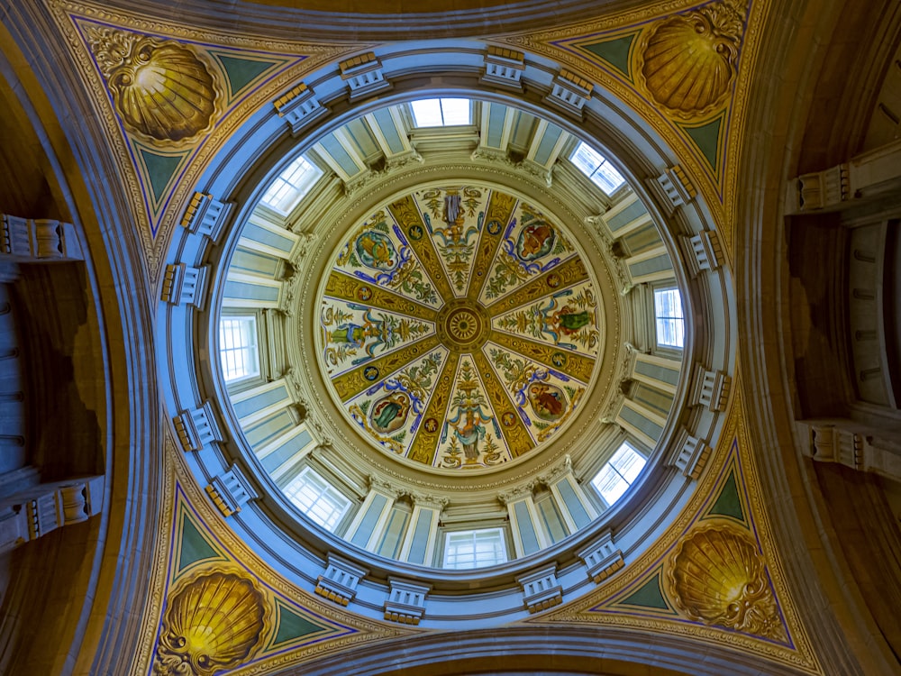 the ceiling of a large building with a circular stained glass window