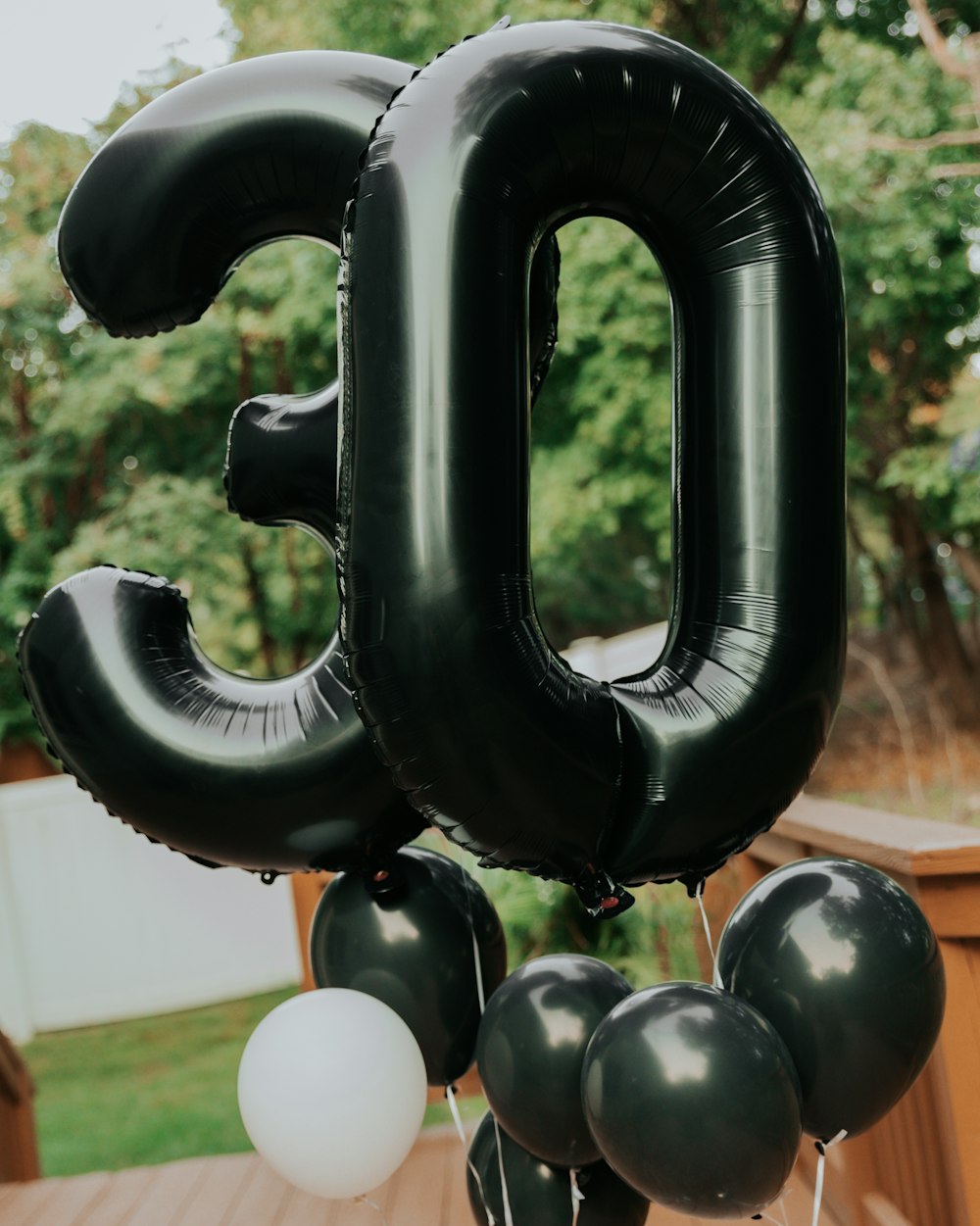 A number 50 balloon with balloons attached to it photo – Free At