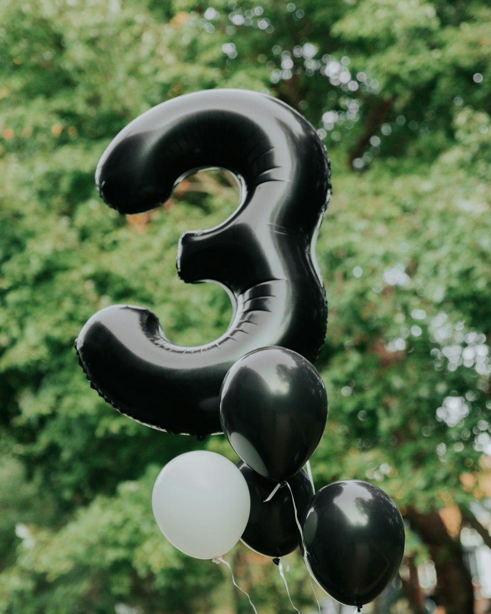 a number 3 balloon with balloons attached to it