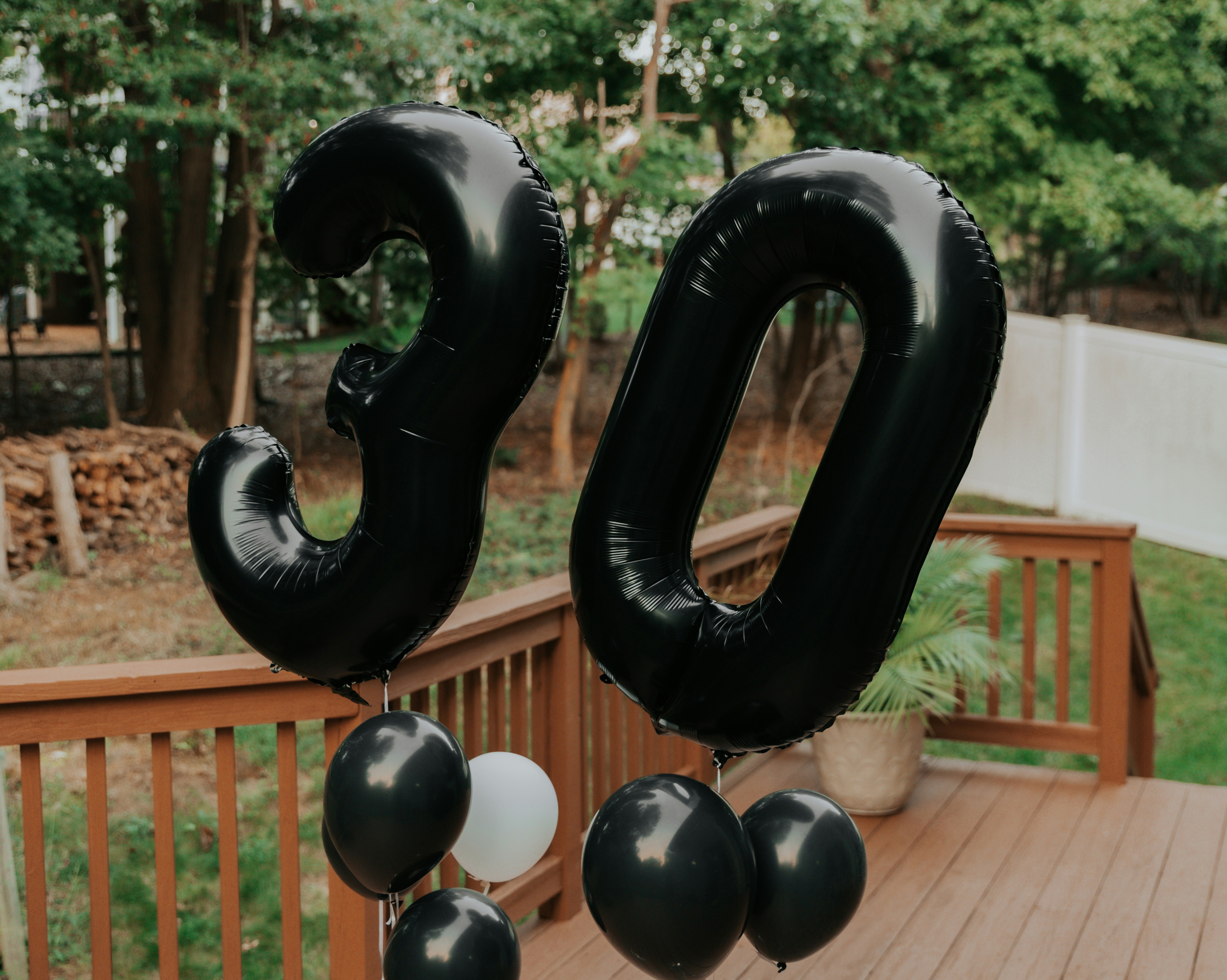 a couple of balloons that are on a wooden deck
