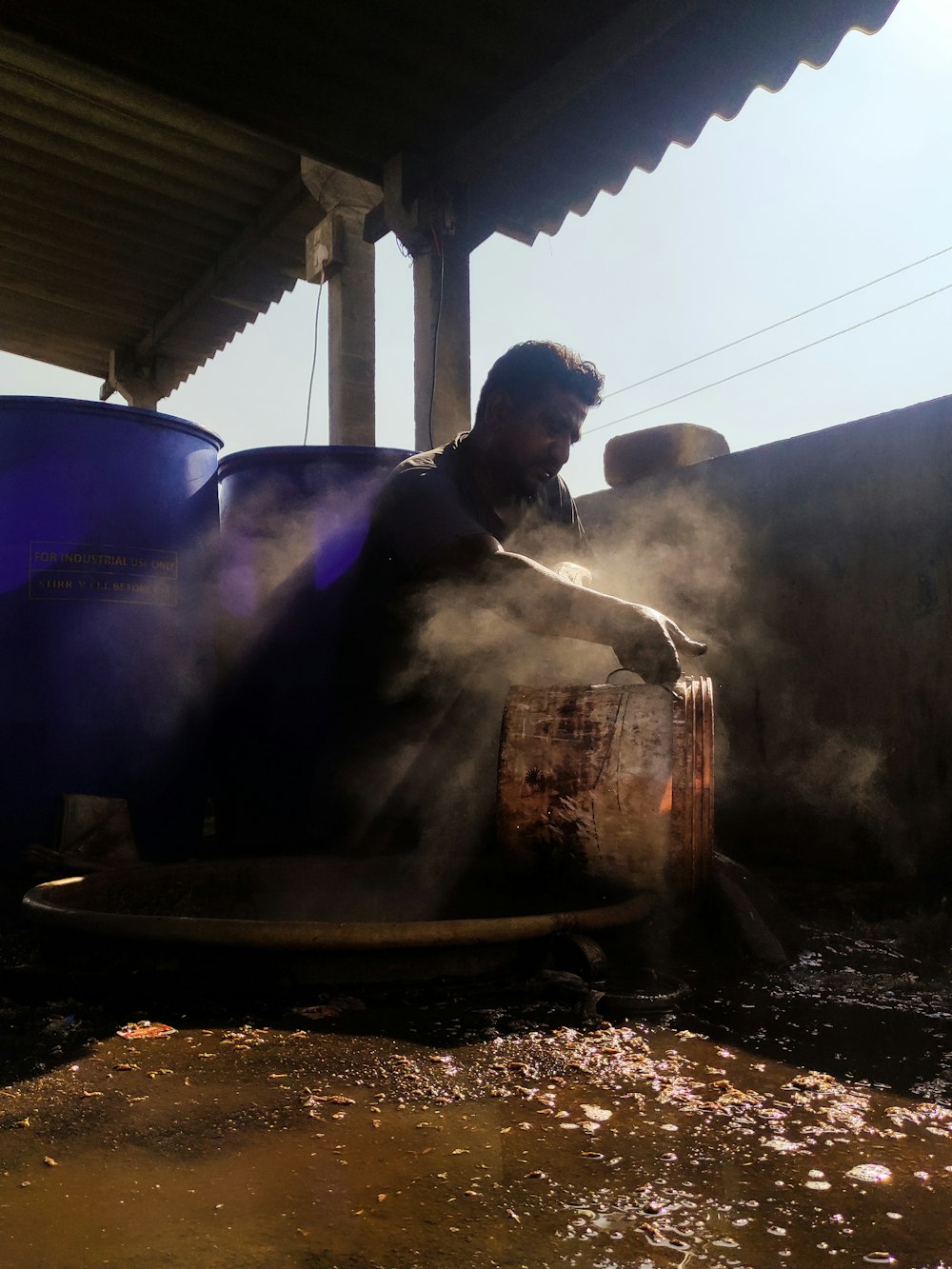 a man is washing his hands in a large pot