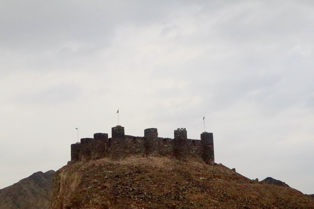 a castle on top of a hill with a sky background