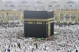 a large group of people surrounding a large black and gold building