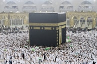 a large group of people surrounding a large black and gold building