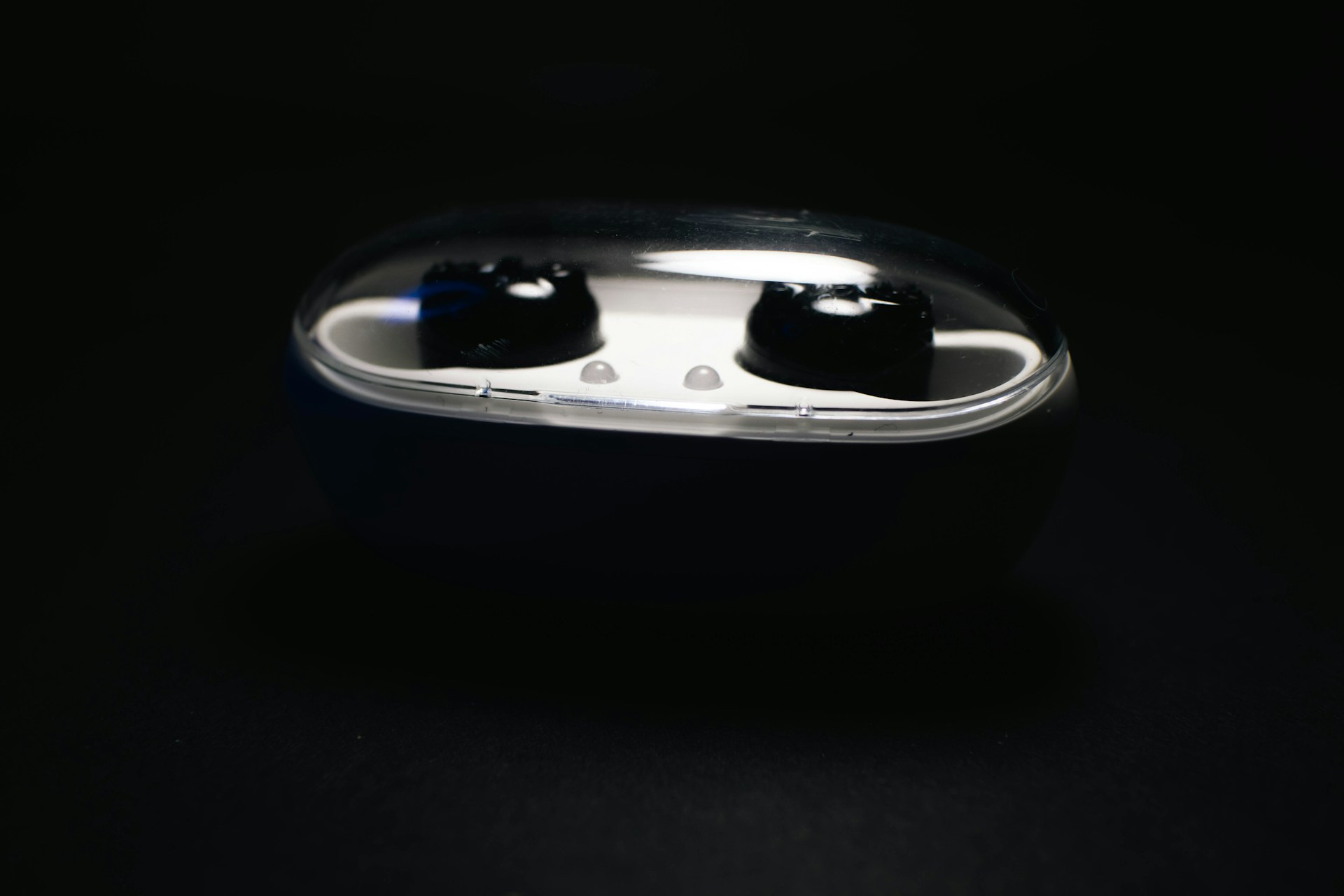 A set of wireless earbuds nestled inside their compact charging case against a clean white background.