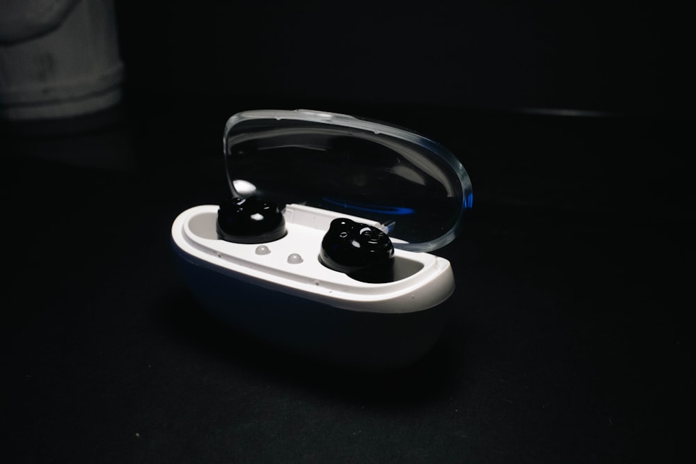 a pair of earbuds sitting in a case on a table