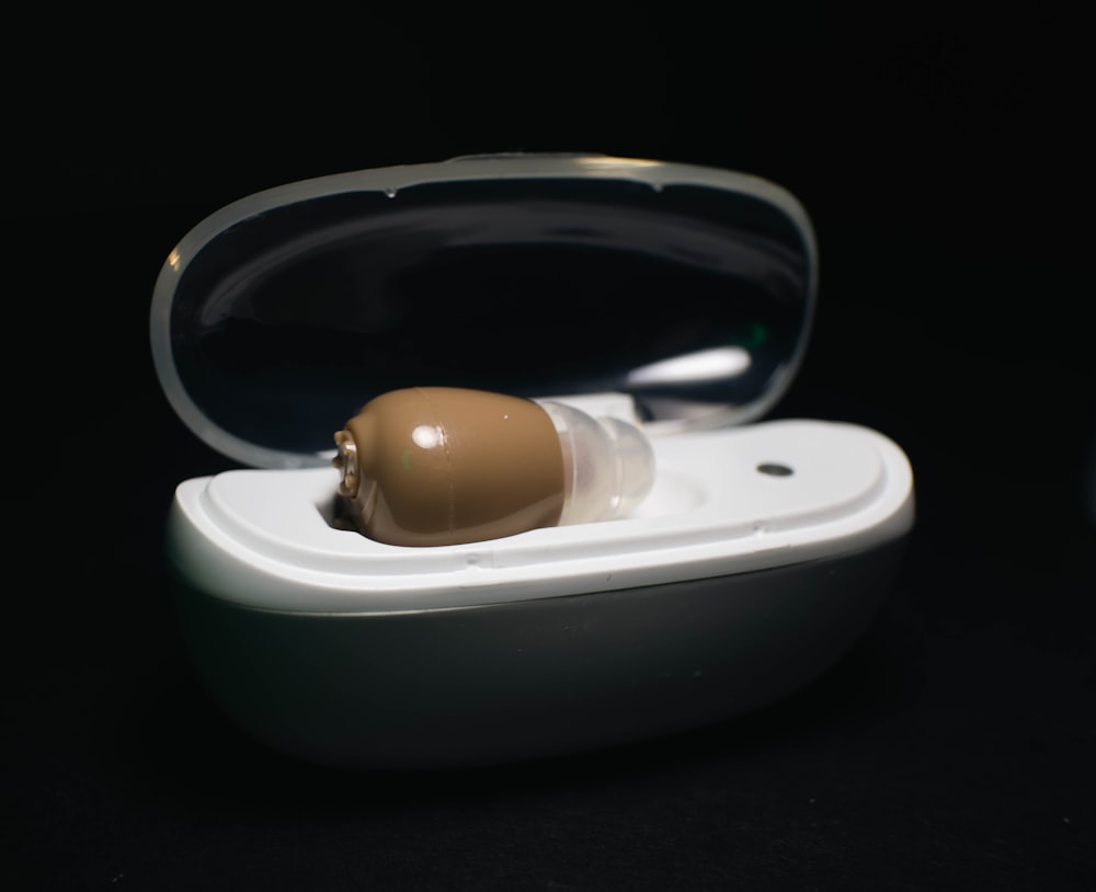 a pair of earbuds in a case on a black surface