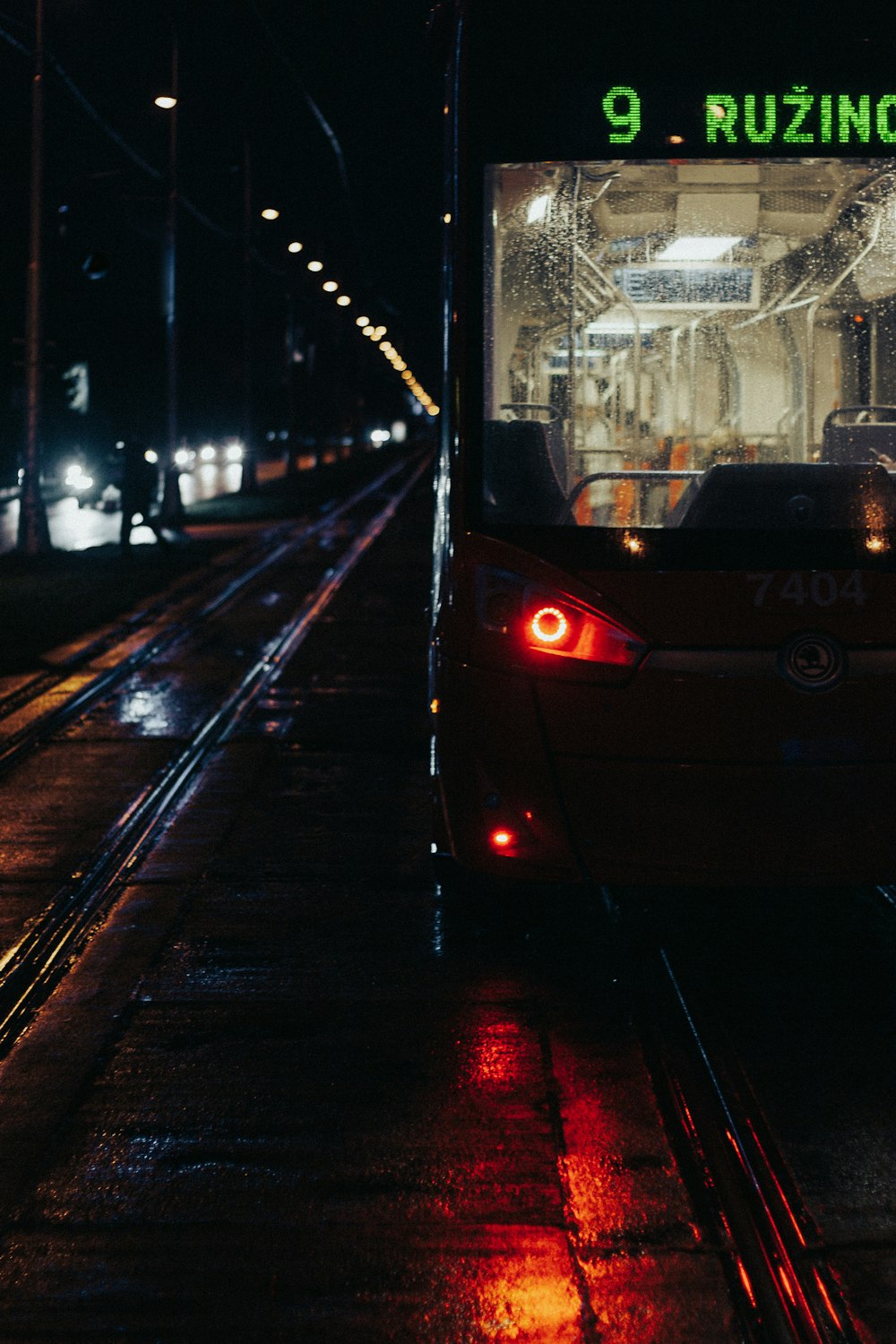 a bus driving down a street at night