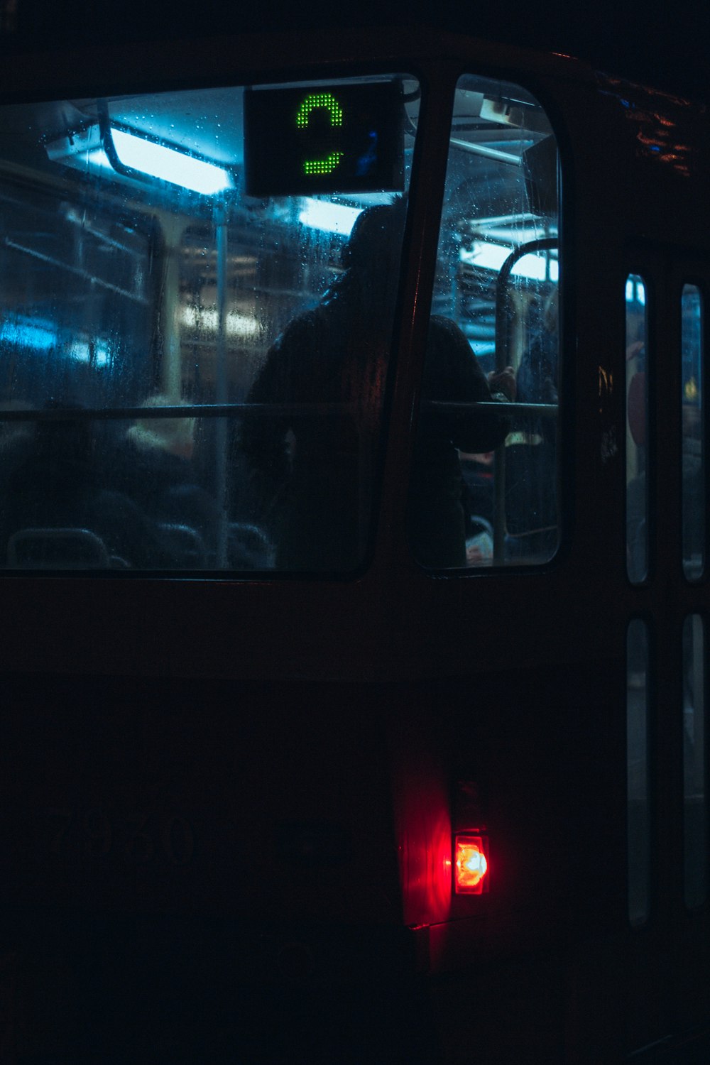 a bus with its lights on in the dark