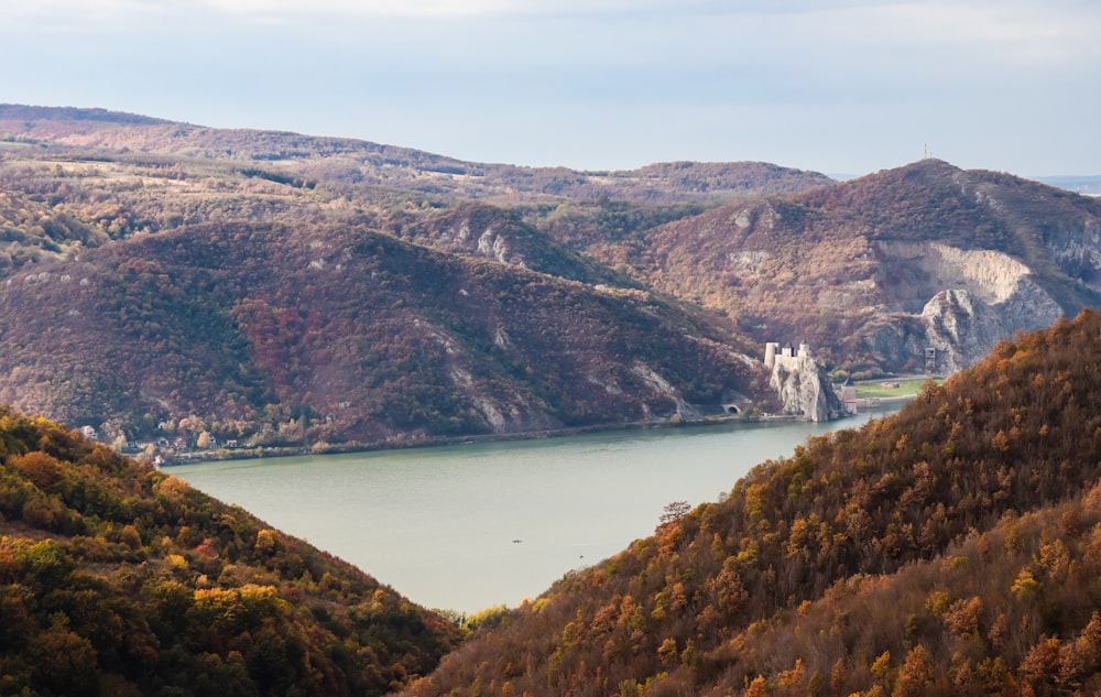 a scenic view of a lake surrounded by mountains