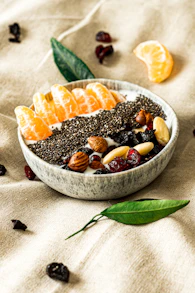 a bowl filled with fruit and nuts on top of a table