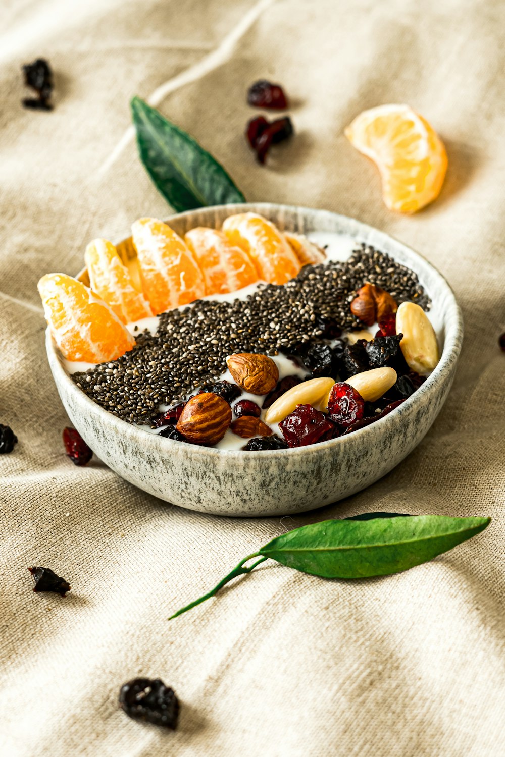 a bowl filled with fruit and nuts on top of a table