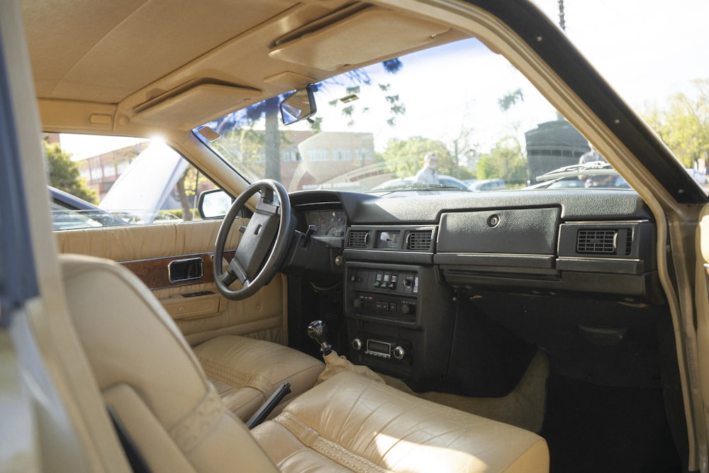 the interior of a car with a steering wheel and dashboard