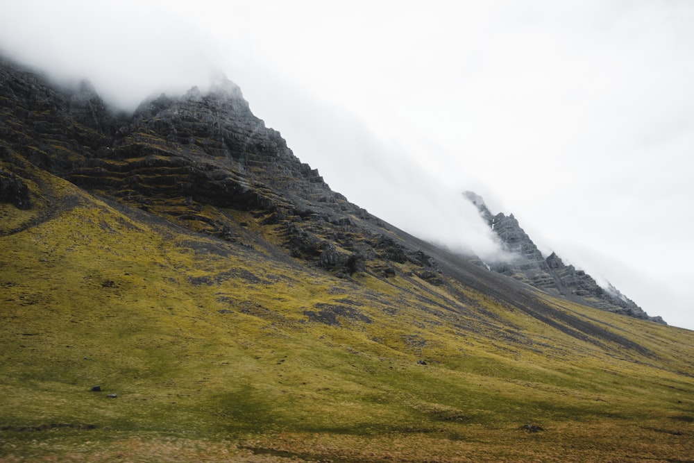 a very tall mountain covered in fog and clouds