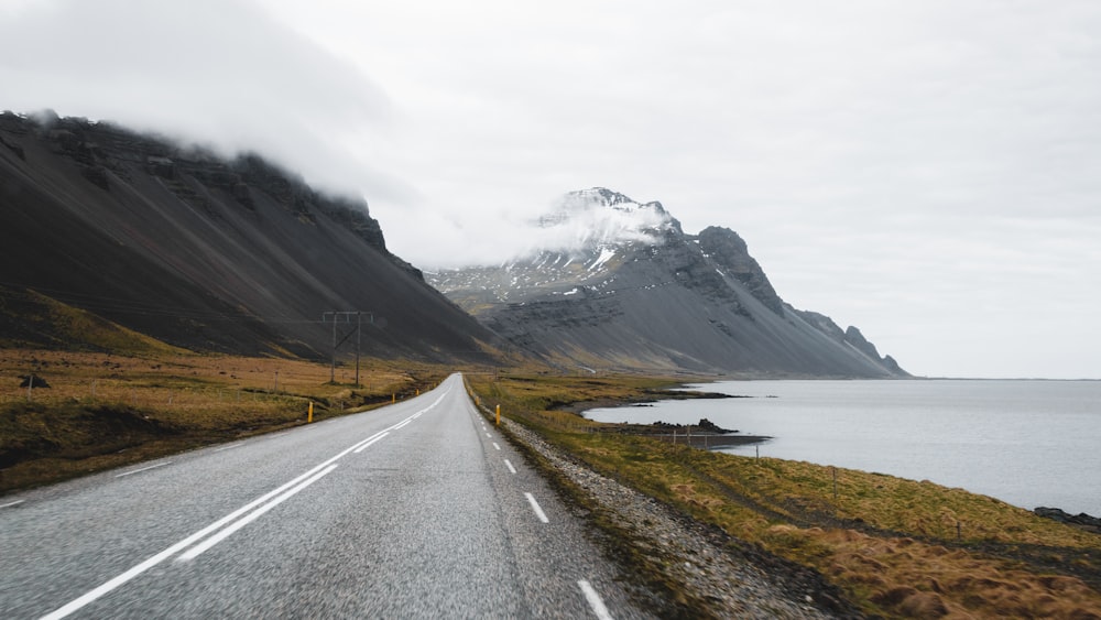 a long road with a mountain in the background