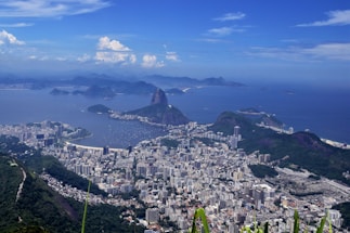 Aerial view of a coastal city with beaches and urban areas.