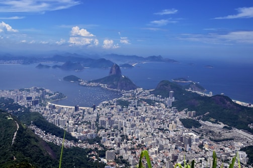 Aerial view of a coastal city with beaches and urban areas.