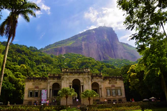 a large building with a mountain in the background
