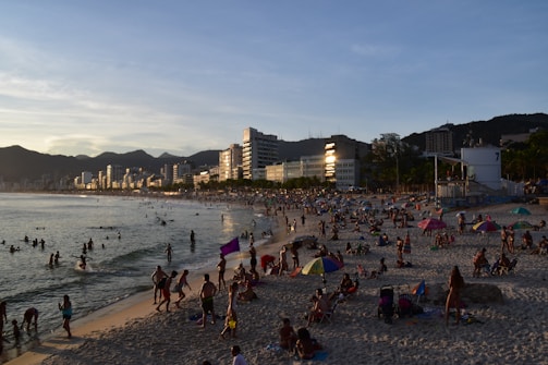 A vibrant Okinawa beach scene with travelers enjoying the sunset.