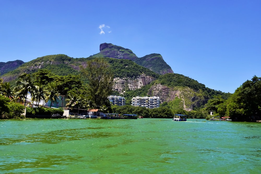 a body of water with a mountain in the background