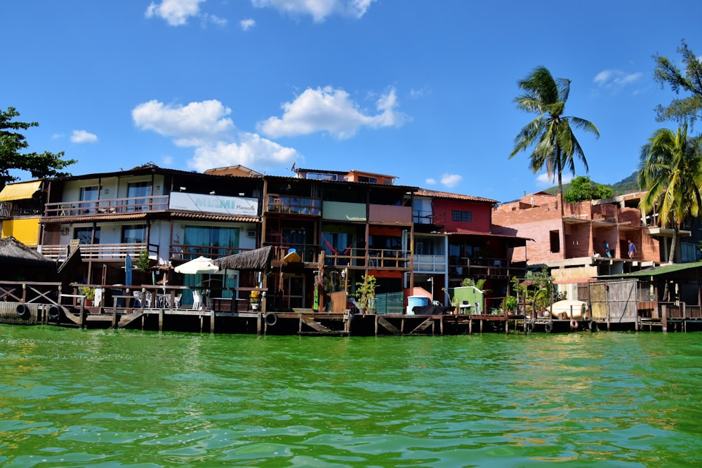 a group of houses sitting on top of a wooden pier